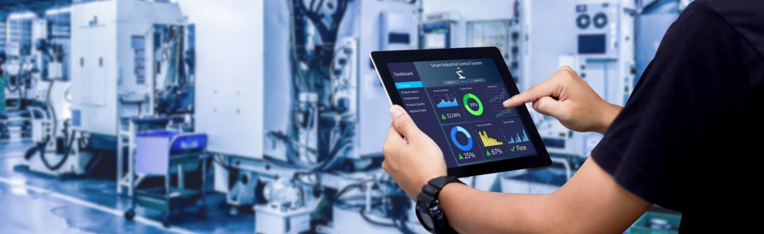 Hands holding tablet on blurred automation machine as background